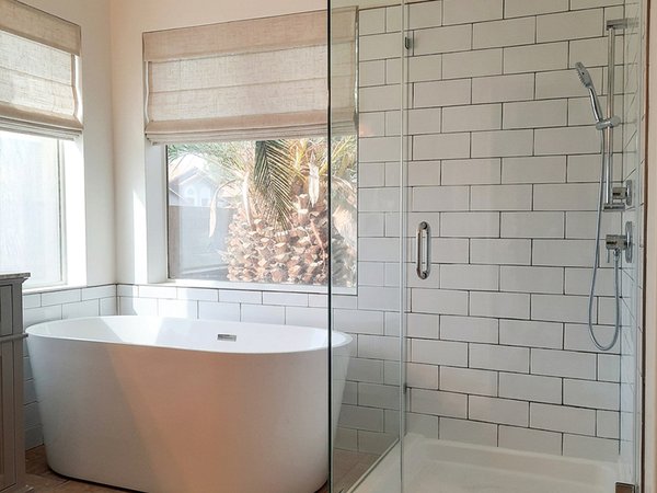 Remodeled bathroom with freestanding tub and subway-tile glass shower by Typhoon Builders